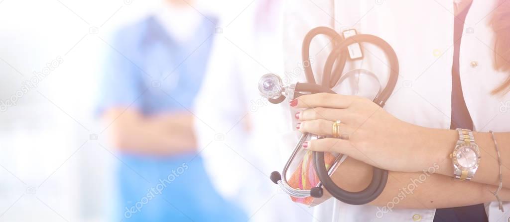 Woman doctor standing with stethoscope at hospital 