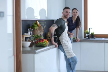 Güzel genç çift evde mutfakta eğleniyor.