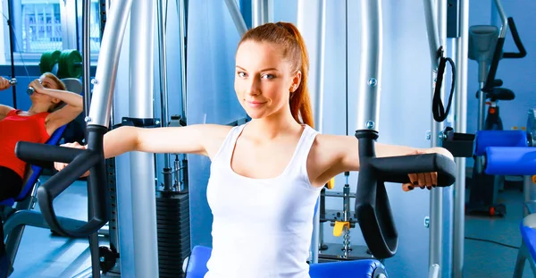 Young woman doing fitness exercises with expander — Stock Photo, Image