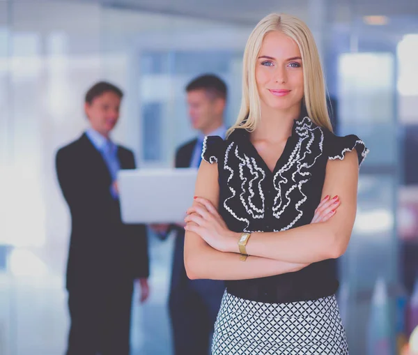 Zakenvrouw permanent op voorgrond in office — Stockfoto