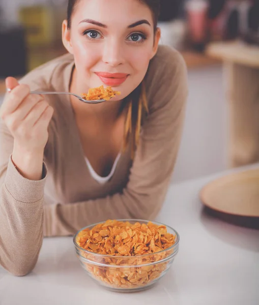 Lachende aantrekkelijke vrouw ontbijten in keuken interieur — Stockfoto