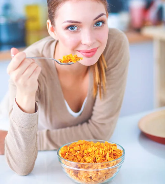 Lachende aantrekkelijke vrouw ontbijten in keuken interieur — Stockfoto