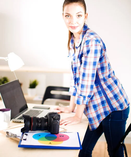 Kvinnlig fotograf sitter på skrivbordet med laptop. Kvinnlig fotograf — Stockfoto