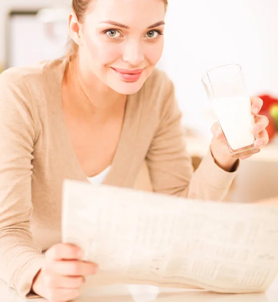 Smiling attractive woman having breakfast in kitchen interior. Smiling attractive woman.