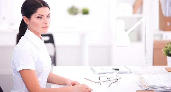 Attractive businesswoman sitting in the office, isolated — Stock Photo, Image