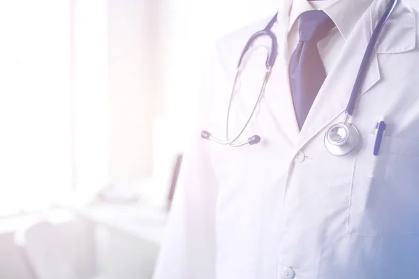 Medical doctor with a stethoscope standing in office — Stock Photo, Image