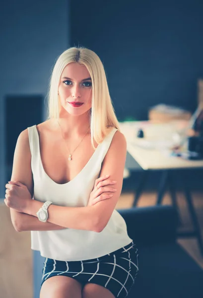 Fashion designers working in studio sitting on the desk. — Stock Photo, Image