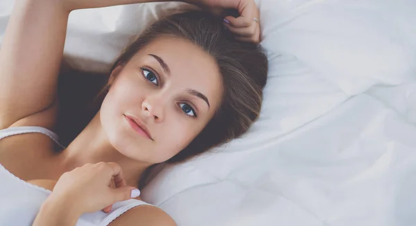 Young beautiful woman lying in bed — Stock Photo, Image