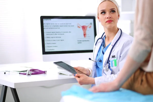 Dokter en patiënt bespreken iets terwijl ze aan tafel zitten. Geneeskunde en gezondheidszorg. Dokter en patiënt — Stockfoto