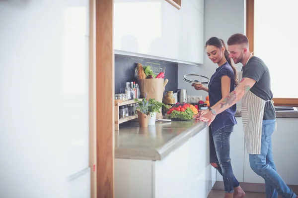 Couple cooking together in their kitchen at home — Stock Photo, Image