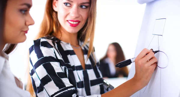 Young woman with folder writing on board — Stock Photo, Image