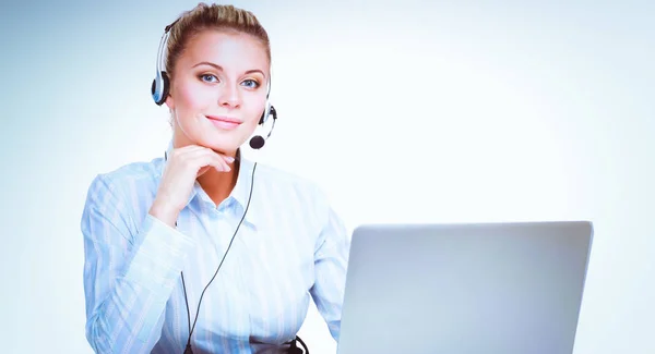 Portrait of beautiful business woman working at her desk with headset and laptop. — Stock Photo, Image