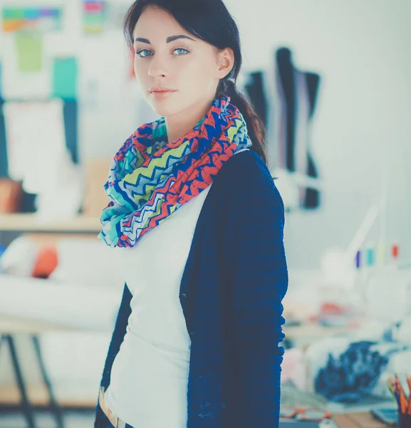 Beautiful young fashion designer standing in studio — Stock Photo, Image