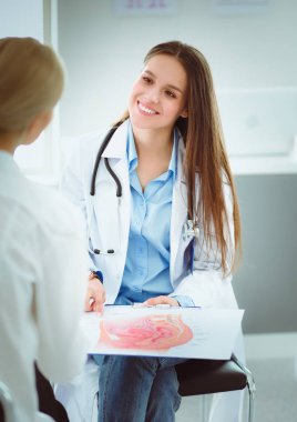 Doktor ve hasta masada otururken bir şey tartışıyorlar. İlaç ve sağlık hizmetleri kavramı