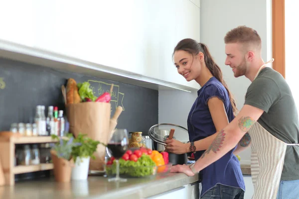 Bir çift evdeki mutfaklarında birlikte yemek pişiriyor. — Stok fotoğraf