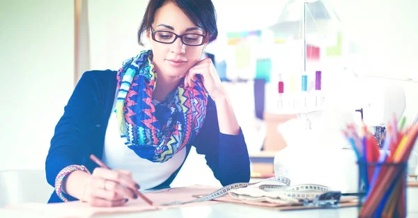 Young dressmaker designing clothes pattern on paper — Stock Photo, Image