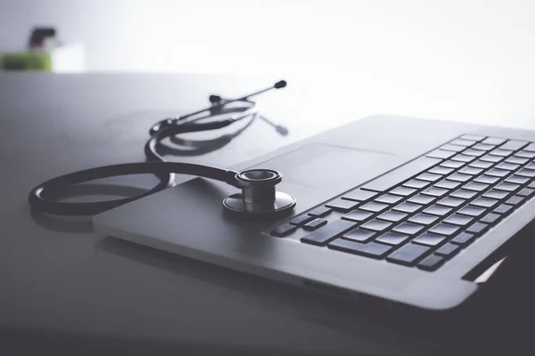 Workplace of doctor with laptop and stethoscope and notebook — Stock Photo, Image