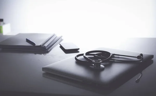 Workplace of doctor with laptop and stethoscope and notebook — Stock Photo, Image