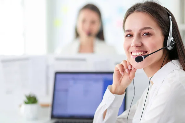 Smiling businesswoman or helpline operator with headset and computer at office — Stock Photo, Image