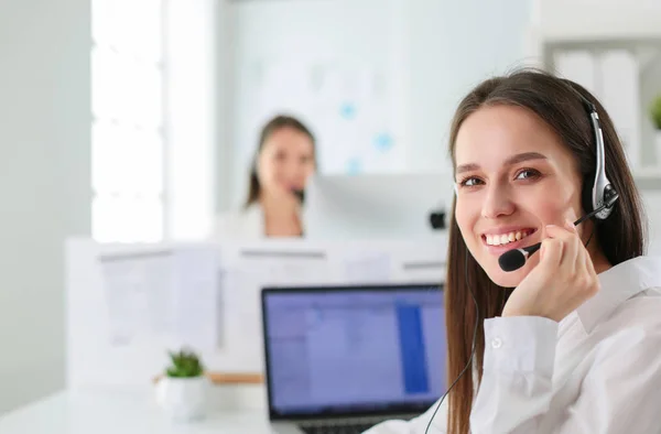 Smiling businesswoman or helpline operator with headset and computer at office — Stock Photo, Image