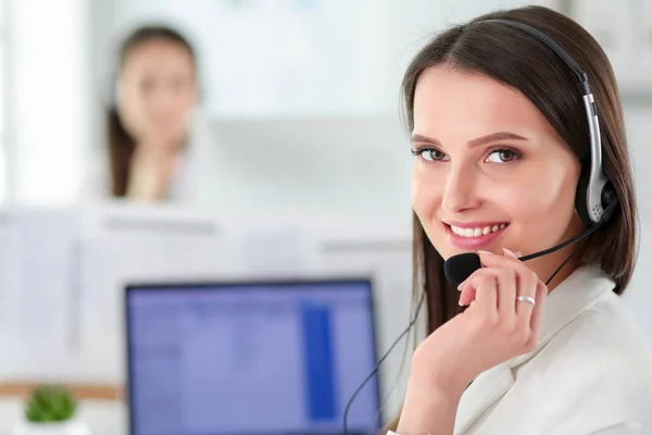 Smiling businesswoman or helpline operator with headset and computer at office — Stock Photo, Image