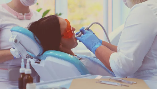 Young woman dentist at work in the office — Stock Photo, Image