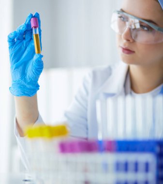 Laboratuvar asistanı bir kan örneğini analiz ediyor.