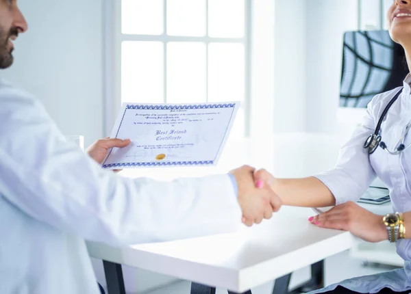 El médico da la mano a un paciente aislado sobre fondo blanco — Foto de Stock