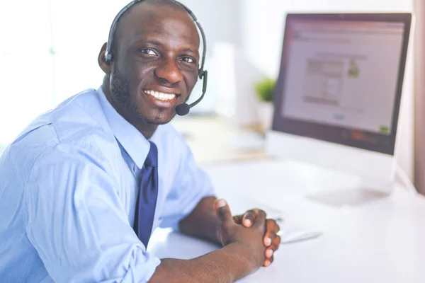 African american businessman on headset working on his laptop — Stock Photo, Image