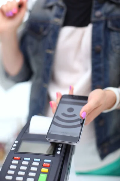 Customer is paying with smartphone in shop using NFC technology. NFC technology. Customer is paying — Stock Photo, Image