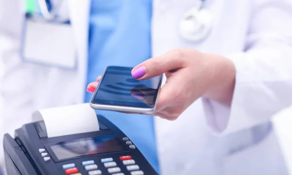 Doktor drží platební terminál v rukou. Platit za zdravotní péči. Doktor — Stock fotografie