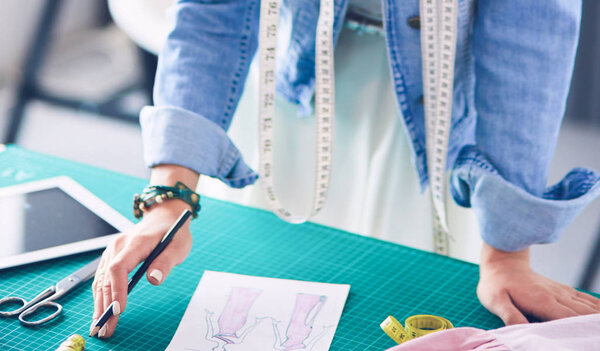 Fashion designer woman working on her designs in the studio