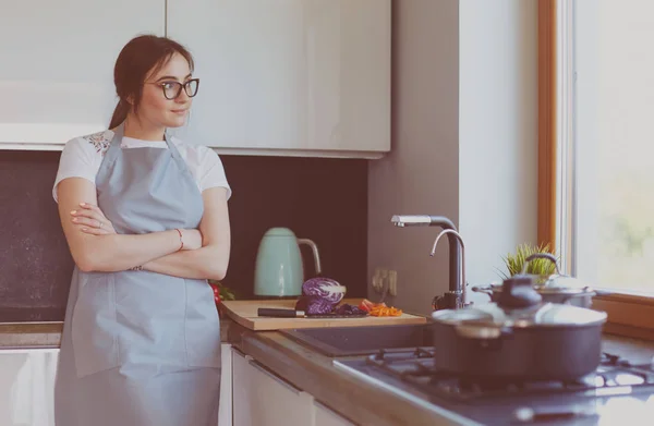 Frau kocht in neuer Küche und bereitet gesunde Lebensmittel mit Gemüse zu — Stockfoto