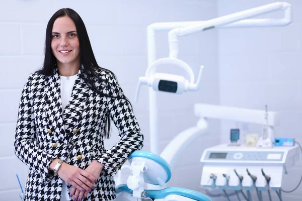 Woman dentist standing in her office smiling — Stock Photo, Image