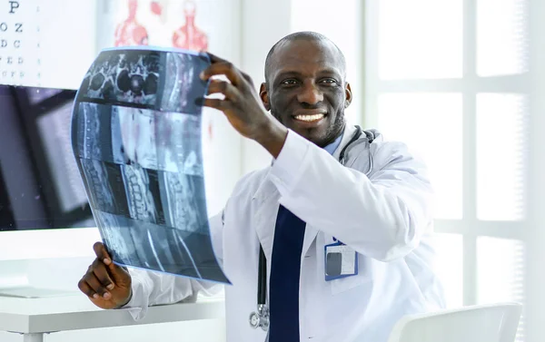 Portrait young african medical doctor holding patients x-ray — Stock Photo, Image