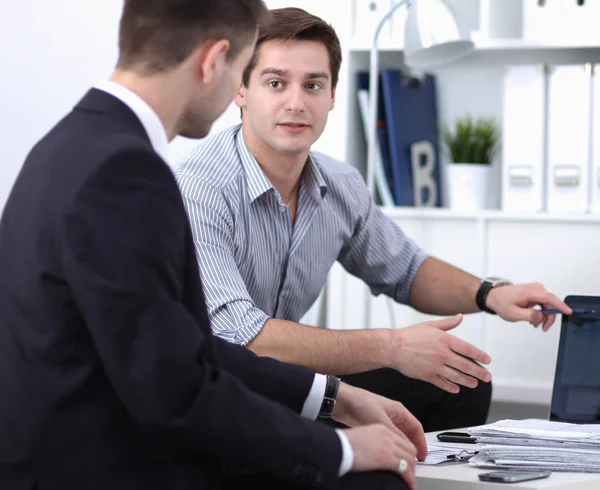 Business people working together at desk, white background