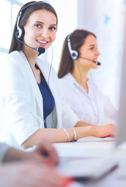 Smiling businesswoman or helpline operator with headset and computer at office — Stock Photo, Image