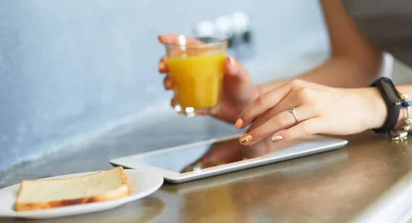 キッチンに立っている間にオレンジジュースのガラスを保持する魅力的な女性 — ストック写真