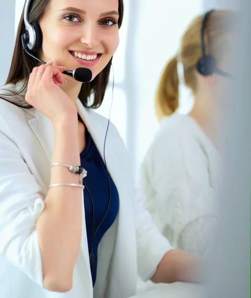 Smiling businesswoman or helpline operator with headset and computer at office — Stock Photo, Image