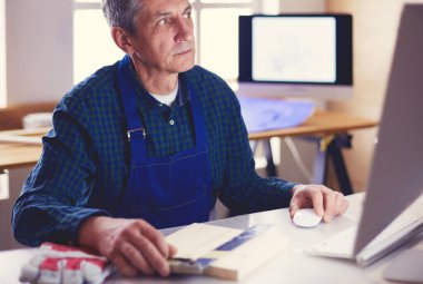 Ofisteki çizim masasında çalışan mimar