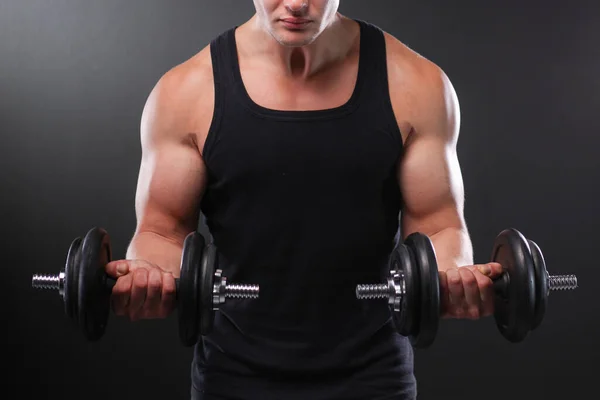 Stylish shirtless man at the dark wall — Stock Photo, Image