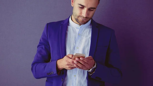 Young businessman sitting isolated on grey background. — Stock Photo, Image