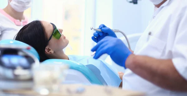 Beautiful senior woman at dentist having dental treatment at dentists office — Stock Photo, Image