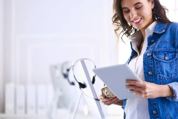 Mujer sonriente bebiendo café y usando la tableta en el café — Foto de Stock