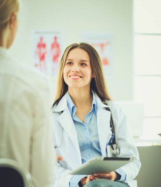 Doktor ve hasta masada otururken bir şey tartışıyorlar. İlaç ve sağlık hizmetleri kavramı