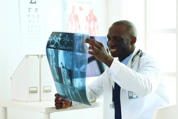 Portrait young african medical doctor holding patients x-ray — Stock Photo, Image