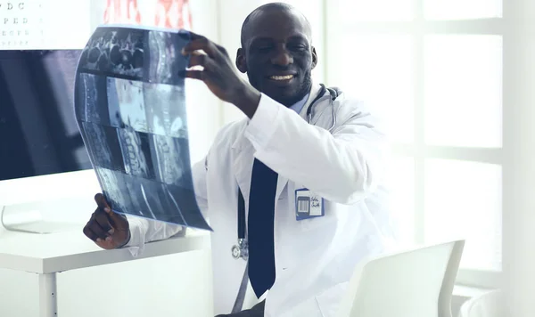 Portrait young african medical doctor holding patients x-ray — Stock Photo, Image