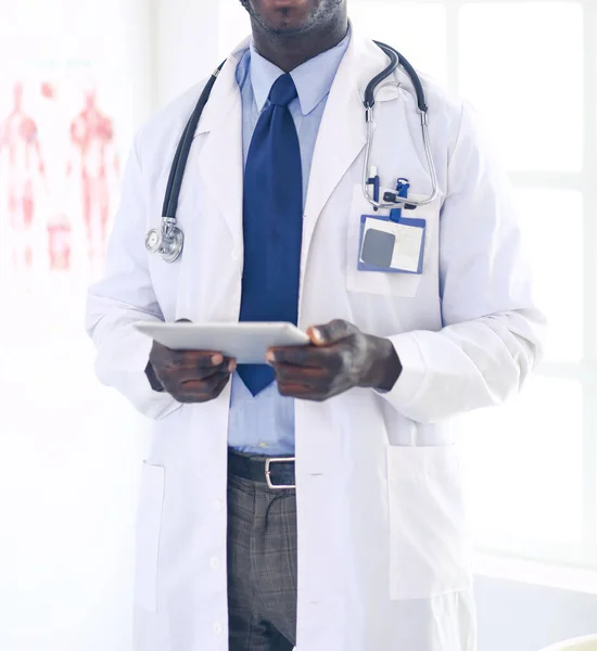 Male black doctor worker with tablet computer standing in hospital