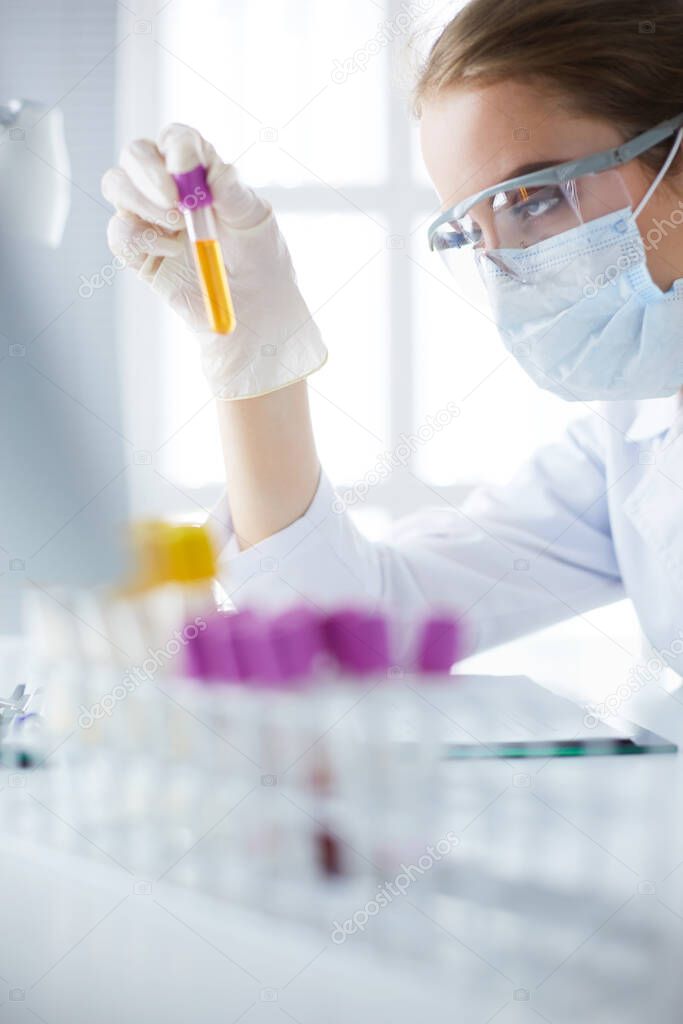 Woman researcher is surrounded by medical vials and flasks, isolated on white