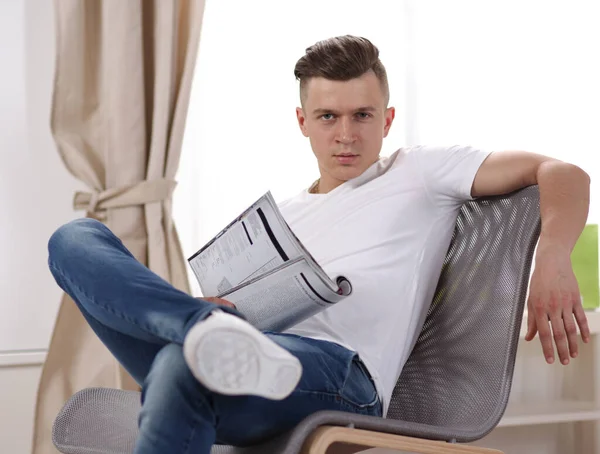 Handsome confident man sitting in armchair at home — Stock Photo, Image